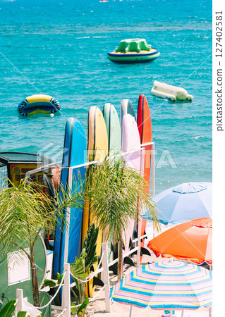 Summer beach resort with colorful surfboards Summer beach resort with colorful surfboards 127402581