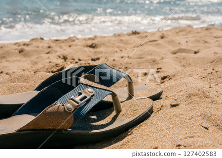 Sandals on the beach and the summer sea 127402583