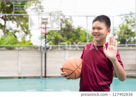 Teenage Boy on Basketball Court in Sportswear Teenage Boy on Basketball Court in Sportswear 127402636