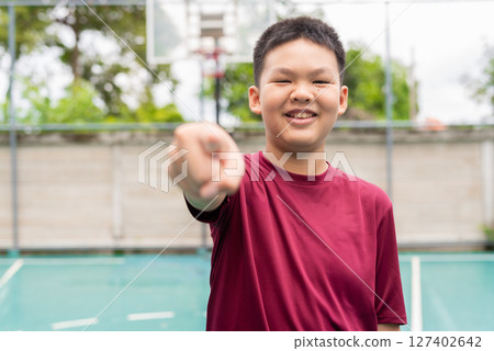 Teenage Boy on Basketball Court in Sportswear Teenage Boy on Basketball Court in Sportswear 127402642