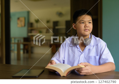 Thai Student in School Uniform Studying in Library Thai Student in School Uniform Studying in Library 127402790