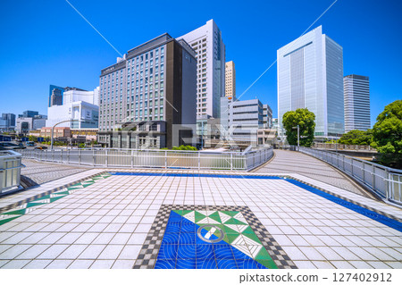 Yokohama cityscape in Japan: Sakuragicho Station, New South Exit (City Hall Exit), Hotel Mets, Yokohama City Hall, and more seen from Sakuragibashi Bridge 127402912