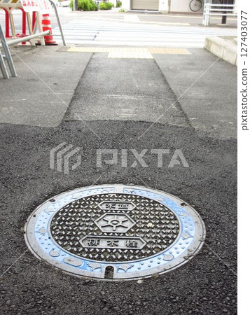 Drain plug installed on the sidewalk 127403077
