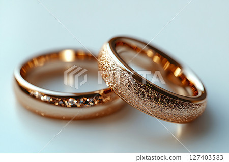 Pair of white gold wedding rings on a white background. Original style. 127403583