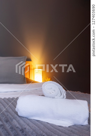 White towel on bed in guest room in hotel 127403690