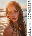 Beautiful young woman in swimsuit in sunset light by sea. Portrait 127403837