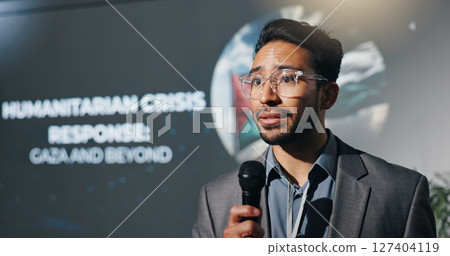 Man, speech and mic at seminar event for genocide, humanitarian crisis and response. Person, public speaking and raise awareness for global oppression, stop injustice and action for war in Palestine 127404119