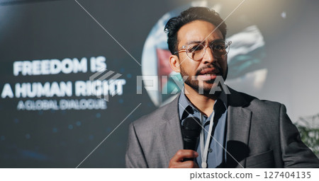 Man, speaker and mic at conference event of conflict, freedom and human rights speech. Person, public speaking and raise awareness for global oppression, stop injustice and action for Palestine peace 127404135