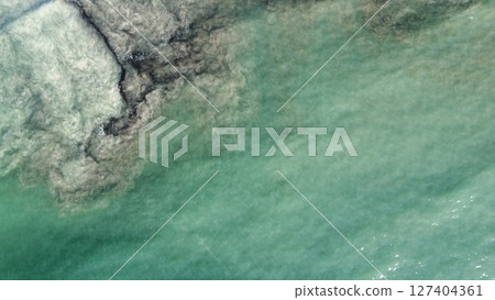 Aerial Abstraction of Foamy Turquoise Ocean Currents 127404361