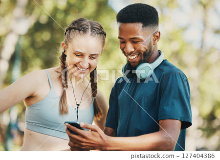 Fitness, social media and couple with phone in a park for training, mobile app and funny video. Communication, comedy and black man and woman reading about a cardio workout on a mobile in nature 127404386