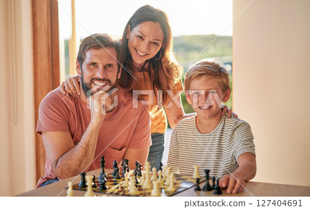 Family, chess and home youth brain development of a mother, father and child with a game. Happy kid and parents portrait with love and care ready for problem solving and knowledge board game 127404691