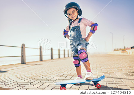 Summer, happy and little girl portrait with skateboard for holiday in Los Angeles with sky mockup. Vacation, sidewalk and cute black child with helmet ready to skate for wellness, health and fun. 127404810