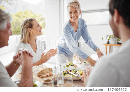Thanksgiving, dinner and woman serving food to family for festive celebration meal, lunch and feast. Love, happiness and big family enjoying holiday, vacation and festival tradition in family home 127404852