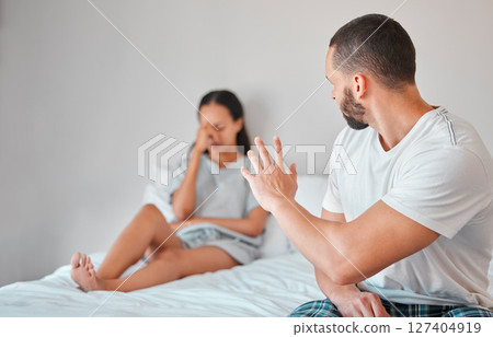 Couple, angry and marriage fight, divorce and stress in bed with mental health, abuse and mistake in relationship. Frustrated, mad and man argument and conflict with woman for infidelity in home 127404919