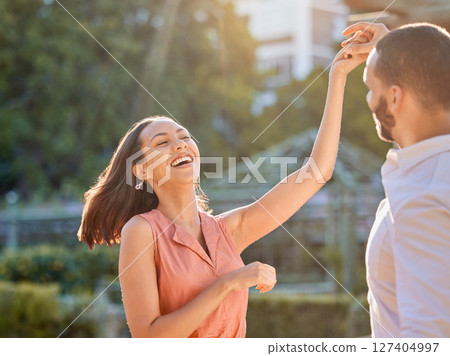 Couple, happy and dance outdoor for love, care and support or relationship bonding together. Woman, dancing celebration with man and quality time or comic romance, happiness and smile in park 127404997