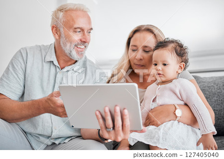 Family, tablet and baby with grandparents on sofa in home on social media, streaming movie or educational app. Relax, love and grandpa, grandma and infant or child with touchscreen tech for cartoons. Family, tablet and baby with grandparents on sofa in home on social media, streaming movie or educational app. Relax, love and grandpa, grandma and infant or child with touchscreen tech for cartoons. 127405040