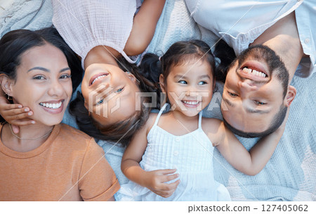 Dad, mom and children relax with outdoor picnic together for family bonding, morning peace and relax in park on a blanket.Top view portrait of happy mother, father with a smile and face of young kids 127405062