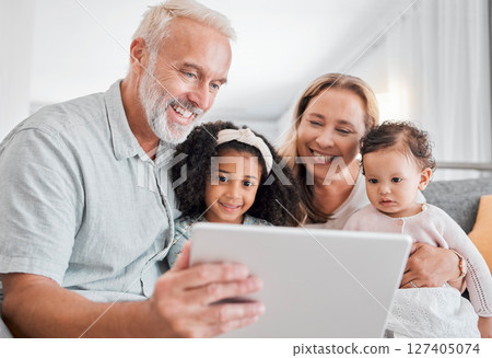 Family, tablet and online browsing with senior people babysitting grandchildren in the family home. Grandfather, grandmother and grandkids with a digital tablet for streaming internet media Family, tablet and online browsing with senior people babysitting grandchildren in the family home. Grandfather, grandmother and grandkids with a digital tablet for streaming internet media 127405074