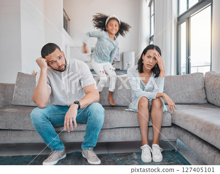 Tired, couple and family with adhd girl jump fast on sofa in house living room or home. Man, woman and parents with burnout, depression or anxiety from autism, energy and mental health kid and stress 127405101