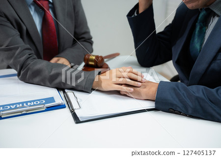 Lawyer comforts his clients with legal advice and serious stress trust commitment for justice issues and lawyer concepts. Lawyer comforts his clients with legal advice and serious stress trust commitment for justice issues and lawyer concepts. 127405137
