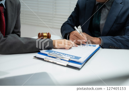 Businessman and Male lawyer or judge consult having team meeting with client, Law and Legal services concept in office. Businessman and Male lawyer or judge consult having team meeting with client, Law and Legal services concept in office. 127405153