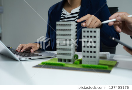 House model with agent asking costumer for contract to buy, get insurance or loan real estate or property. House model with agent asking costumer for contract to buy, get insurance or loan real estate or property. 127405176