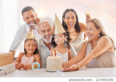 Birthday, party and family with a girl, parents and grandparents in celebration together in their home. Cake, hat and gift with children celebrating a milestone during a happy event in a house 127405266