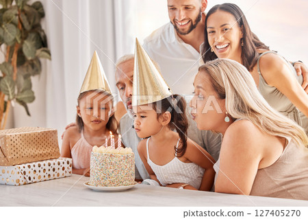 Family, kids and birthday cake with a child and her big family celebrating with a party for fun event. Generations, mother and father with grandparents and grandkids celebrate with dessert or candles 127405270