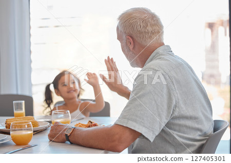 High five, breakfast and family with a girl and grandfather sitting at a dining room table for eating food. Motivation, health and children with a senior man encouraging his grandchild to eat healthy 127405301