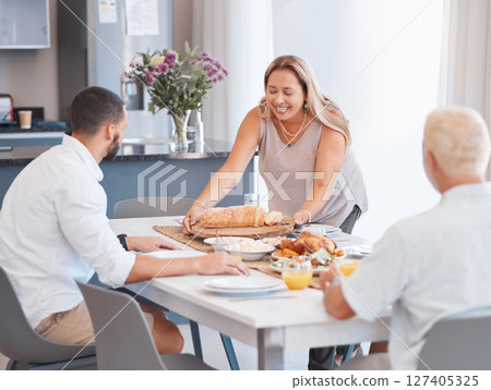 Happy family, thanksgiving or bonding with healthy food on dining table in house or home for holiday party. Smile, happy or mature woman with festive or buffet lunch meal for men in celebration 127405325