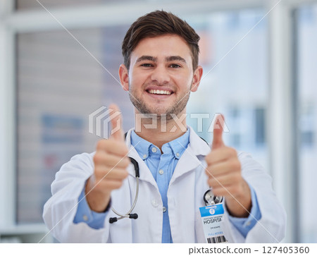 Man, doctor or thumbs up in hospital for support, trust and life insurance vote for healthcare wellness, medical help or surgery success. Portrait, smile or happy medicine worker with approval hands 127405360