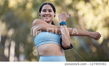 Stretching, thinking and woman training in nature with music on earpods for motivation, mindset and health. Fitness, idea and athlete with podcast warm up before cardio, workout or pilates in a park 127405481