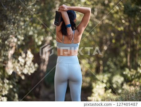 Fitness, workout and woman stretching arms before nature exercise in the forest for athletic stamina. Working out, training and fit female warmup from behind for flexibility and body health Fitness, workout and woman stretching arms before nature exercise in the forest for athletic stamina. Working out, training and fit female warmup from behind for flexibility and body health 127405487