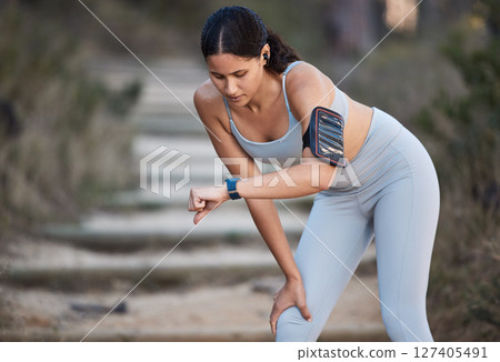 Fitness, runner and woman running with smartwatch, check time and health monitor, heart rate and cardio during workout outdoor. Exercise, break and training for marathon or wellness with sport tech. Fitness, runner and woman running with smartwatch, check time and health monitor, heart rate and cardio during workout outdoor. Exercise, break and training for marathon or wellness with sport tech. 127405491