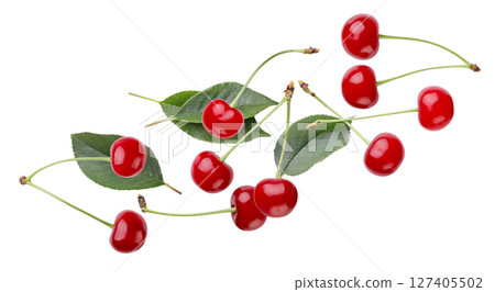 Red cherries and leaves flying close-up on a white. Isolated 127405502