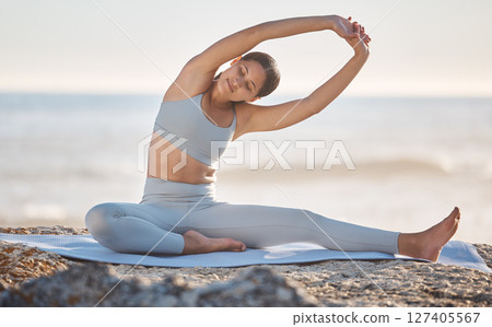 Stretching, fitness and woman with peace at the beach, freedom and exercise for healthy mindset in nature. Yoga, meditation and girl with a morning warm up to relax before a workout by the ocean 127405567