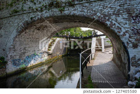 Southall, Greater London, UK: The Grand Union Canal at Southall in London. This is lock number 90, the Norwood Top Lock framed by a bridge. 127405580