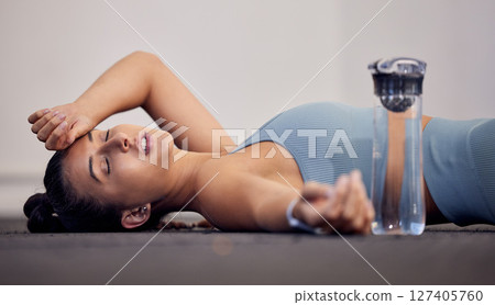 Gym floor, fatigue and woman tired after intense workout, cardio training or yoga fitness exercise. Medical dehydration problem, emergency accident injury and sports athlete faint in pilates studio 127405760
