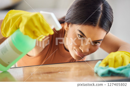 Black woman, hands and detergent for cleaning hygiene, domestic or health and safety from bacteria at home. African American female spraying wooden table, counter top or furniture for clean sanitary Black woman, hands and detergent for cleaning hygiene, domestic or health and safety from bacteria at home. African American female spraying wooden table, counter top or furniture for clean sanitary 127405802