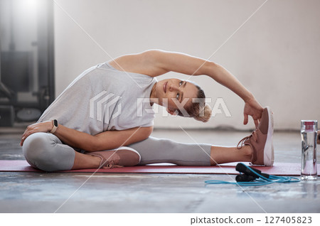 Stretching, fitness and training with woman in gym with water bottle for pilates, workout and health. Relax, exercise and sports with girl athlete and warm up for performance, cardio and jump rope 127405823