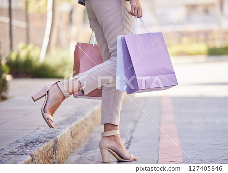 Shopping bag, woman customer and city street for retail fashion, clothes or luxury. Discount, sale and summer choice of girl shoes, legs and feet lifestyle walking with paper bag for rich or wealth Shopping bag, woman customer and city street for retail fashion, clothes or luxury. Discount, sale and summer choice of girl shoes, legs and feet lifestyle walking with paper bag for rich or wealth 127405846
