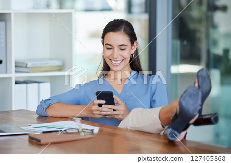 Smile office and phone, typing with feet up on desk, relax while surfing internet or social media with smile on face. Communication, smartphone and happy businesswoman ceo writing text while on break Smile office and phone, typing with feet up on desk, relax while surfing internet or social media with smile on face. Communication, smartphone and happy businesswoman ceo writing text while on break 127405868