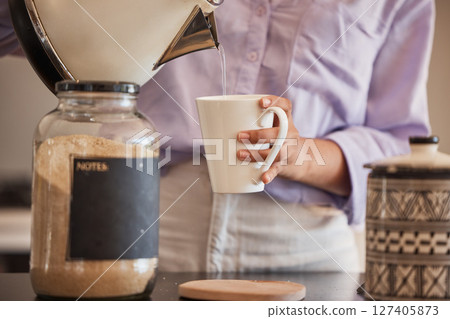 Water, drink and woman make coffee in kitchen for motivation, energy and caffeine in morning. Lifestyle, cafe and closeup of hands pouring water from kettle to mug for hot beverage, espresso and tea Water, drink and woman make coffee in kitchen for motivation, energy and caffeine in morning. Lifestyle, cafe and closeup of hands pouring water from kettle to mug for hot beverage, espresso and tea 127405873