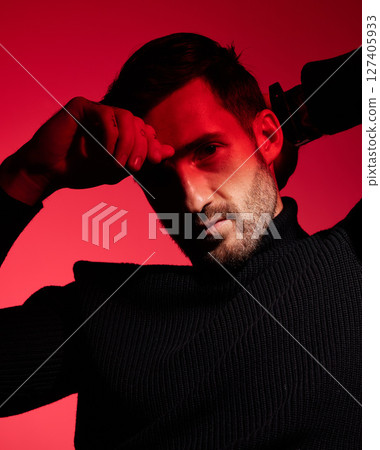 Art, fashion and portrait of man in red background with serious expression on face in studio. Health, beauty and wellness, designer advertisement, sexy man or male model in red light and sensual look 127405933