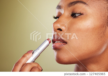 Lipstick, black woman and skincare for wellness, cosmetics, smooth lips or against brown studio background. Makeup, African American female or girl with lip balm, for gloss or soft for natural beauty 127405965