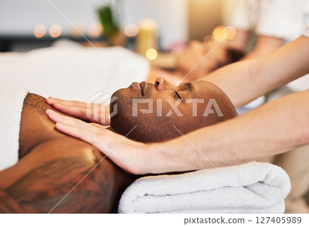 Massage, spa and black man with therapist hands, relax and skincare with zen, peace and wellness on bed. Physical therapy, healing and body therapy, relaxing and luxury treatment with therapist hand 127405989