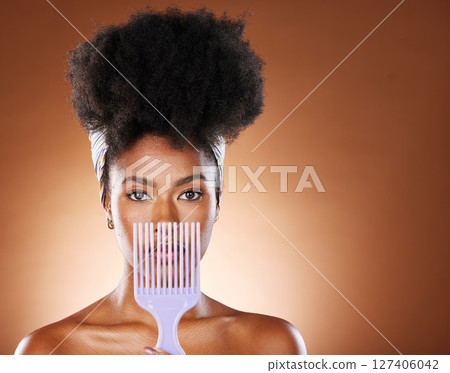 Black woman, hair care beauty or model with afro comb in brown studio background portrait. Health salon, wellness or African American girl and face with natural curly hair and mockup with brush Black woman, hair care beauty or model with afro comb in brown studio background portrait. Health salon, wellness or African American girl and face with natural curly hair and mockup with brush 127406042