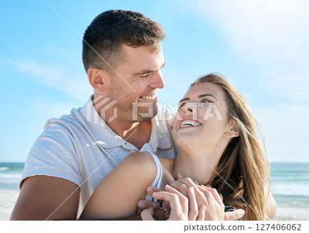 Love, couple and hug with face, beach and happy with smile for relationship, romantic date or vacation together. Romance, man and woman look at each other, happiness and embrace for travel or holiday 127406062