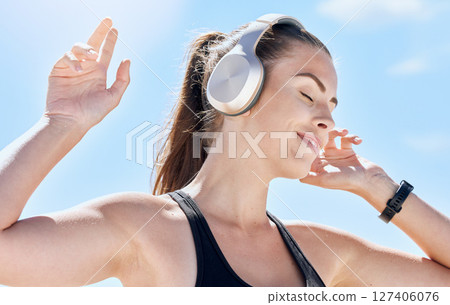 Music, summer and dance with a woman outdoor in nature against a blue sky for dancing or freedom. Radio, relax and carefree with an attractive young female streaming or listening to audio outside 127406076