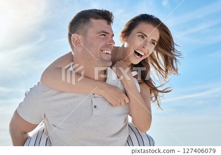 Love, beach and piggy back couple smile with blue sky on romantic summer holiday at ocean. Romance, man and woman have fun at sea for honeymoon, vacation time for happy couple together in Australia. Love, beach and piggy back couple smile with blue sky on romantic summer holiday at ocean. Romance, man and woman have fun at sea for honeymoon, vacation time for happy couple together in Australia. 127406079
